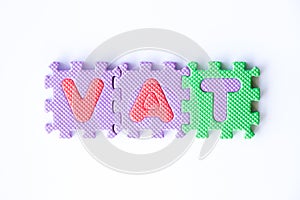 Color toy foam alphabet in word VAT & x28;Abberviation of Value added tax& x29; on white background