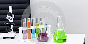 Color water in test tube,microscopes and beaker.Copy space