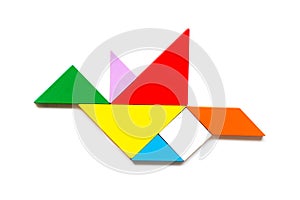 Color wood tangram in flying bird shape on white background