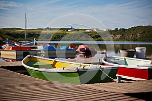 Color Wooden Boats with Paddles in a Lake