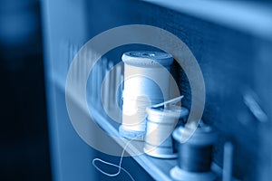 Thread needle button