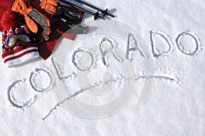 Colorado ski vacation concept, word written in snow with skiing equipment