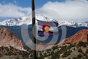 Colorado State Flag with Pikes Peak and Garden of the Gods in th