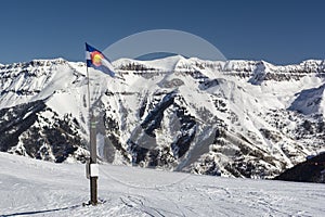 Colorado State Flag in the Rocky Mountains with Snow