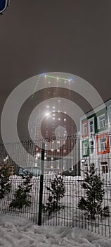 colored apartment buildings in the fog in night