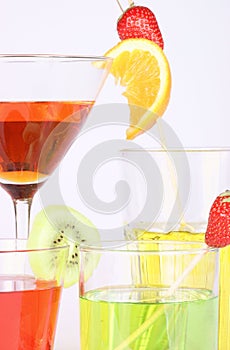 Colored aperitifs in different drinking glasses