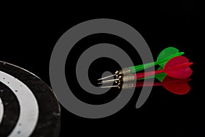 Colored arrows on a black background and target. Hit the target