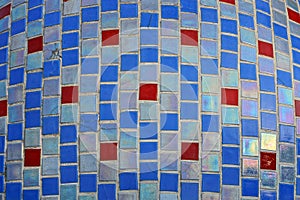 Colored texture of fine ceramic square tiles with a pattern on the wall