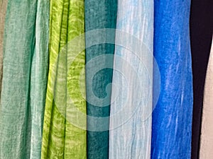 Colored background. hanging scarves of various colors photo