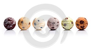 Colored balls of ice cream with nuts and chocolate chips in row