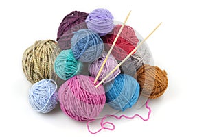 Colored balls of yarn with two knitting needles photo