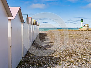 Colored bathing huts and lighthouse at Le Treport beach, Normandy, France photo