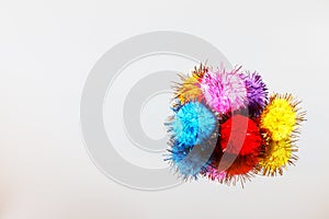 Colored beautiful pompons on a gray background