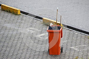 colored bins of garbage collection workers