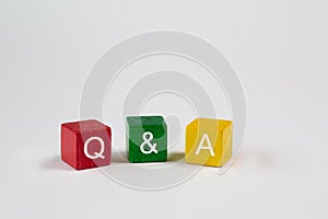 Colored blocks against an isolated white background contain the letters Q & A, which stand for Questions and Answers. Free space i