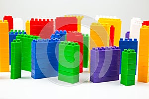 Colored blocks of a plastic constructor on a white background in the form of multi-storey buildings. concept of modern buildings