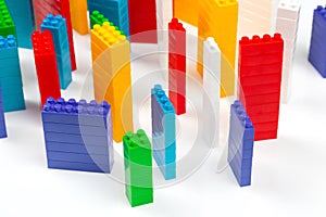 Colored blocks of a plastic constructor on a white background in the form of multi-storey buildings. concept of modern buildings