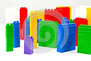 Colored blocks of a plastic constructor on a white background in the form of multi-storey buildings. concept of modern buildings