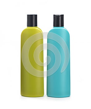 Colored bottles for shampoo on a white background