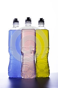 Plastic bottles with colored liquid.