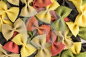 Colored bow tie pasta. Closeup multiple farfalle isolated on white background