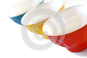 Colored bowls on white background