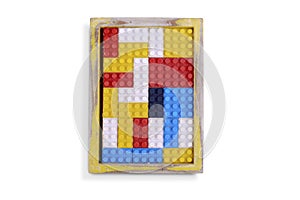 Colored bricks toy in a wooden frame