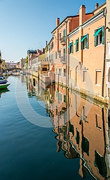 Colored buildings reflection of Vena canal in Chioggia - Italy photo