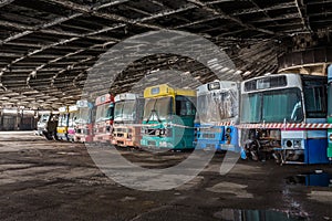 Colored buses in abandoned bus depot