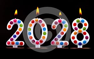 Colored candles write numbers flame Happy new year 2028