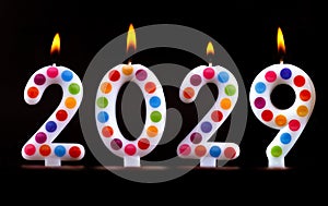 Colored candles write numbers flame Happy new year 2029