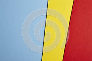 Colored cardboards background in blue yellow red tone. Copy space