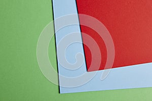 Colored cardboards background in green, blue, red tone. Copy spac