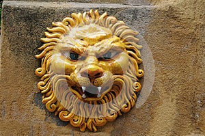 Wall decoration, a lion`s head made of ceramics photo