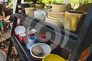 colored ceramic mugs on a wooden shelf