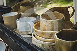 colored ceramic mugs on a wooden shelf