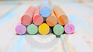 Colored chalk for drawing on a white wood background