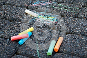 Colored chalk on playground with drawings on street.children drawing on the street. drawing lessons and creativity for kids in