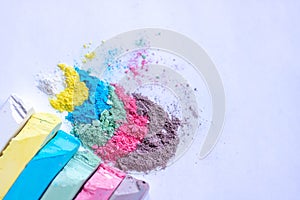 Colored chalk powder and crayons blue purple yellow  on a white background.space for text