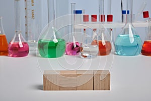 Colored Chemical Flasks and Wooden Cubes - Photo with Copyspace