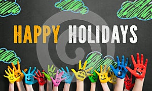 Colored children hands with the message `happy holidays`