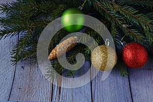 Colored Christmas balls with fir branches on the woods