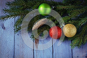 Colored Christmas balls with fir branches on the woods