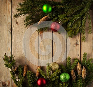 Colored Christmas balls with fir branches on the woods