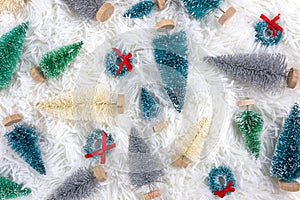 Colored Christmas trees decorations on fluffy white background. Holiday festive celebration greeting card.