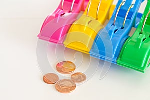 Colored clothespins and coins