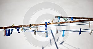 colored clothespins hanging on a rope. rope for drying clothes