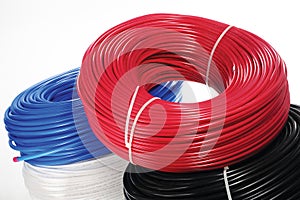 Colored coils of cable on a white background.