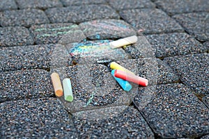 Colored crayons on the pavement, children`s creativity, drawing on the street, multi-colored writing chalk products. Large colore