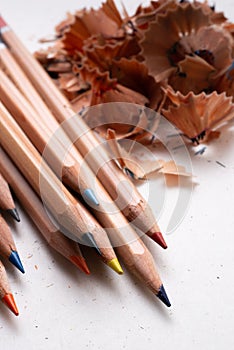 colored crayons with sharp tips on white background